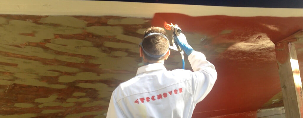 Operatore Tecnover applica vernice antivegetativa su scafo di barca con pompa Airless